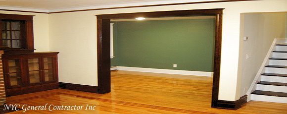 Den area opened up making the entrance wider by supporting the second floor with steel beam - Surrounding the opening with a beautiful custom frame and casing to match the existing woodwork throughout the house... General Contractor