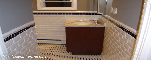 Looking into the main bathroom on the second floor you'll see beveled subway style tiles with navy blue tiles installed throughout the entire bathroom... General Contractor
