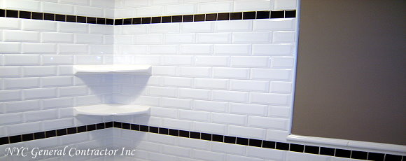Upper half of the tub - shower area along with a additional line of navy blue tiles, complete with elegant matching shelves... General Contractor