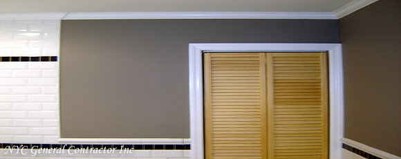Looking to the right of the tub - shower area - We installed louver bi-fold doors covering the towel closet - Encasing the framing with elegant trim molding - Notice how the crown molding and paint make this bathroom complete... General Contractor