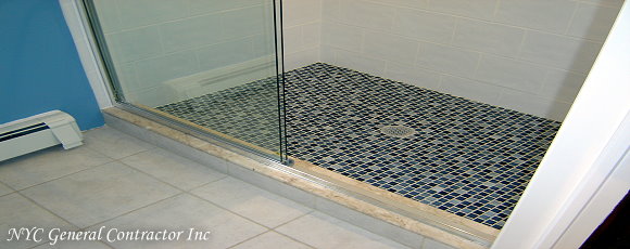 Tada! we have a complete new shower with beautiful tiles - Complete with 1x1 glass tiles covering the shower floor (Elen you owe me one, for that floor!... just kidding!) - Along with a cream colored marble step entering the Shower - Take notice how wonderful the glass sliding shower doors look... General Contractor